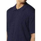 Close-up of navy textured fashion knit polo shirt fabric