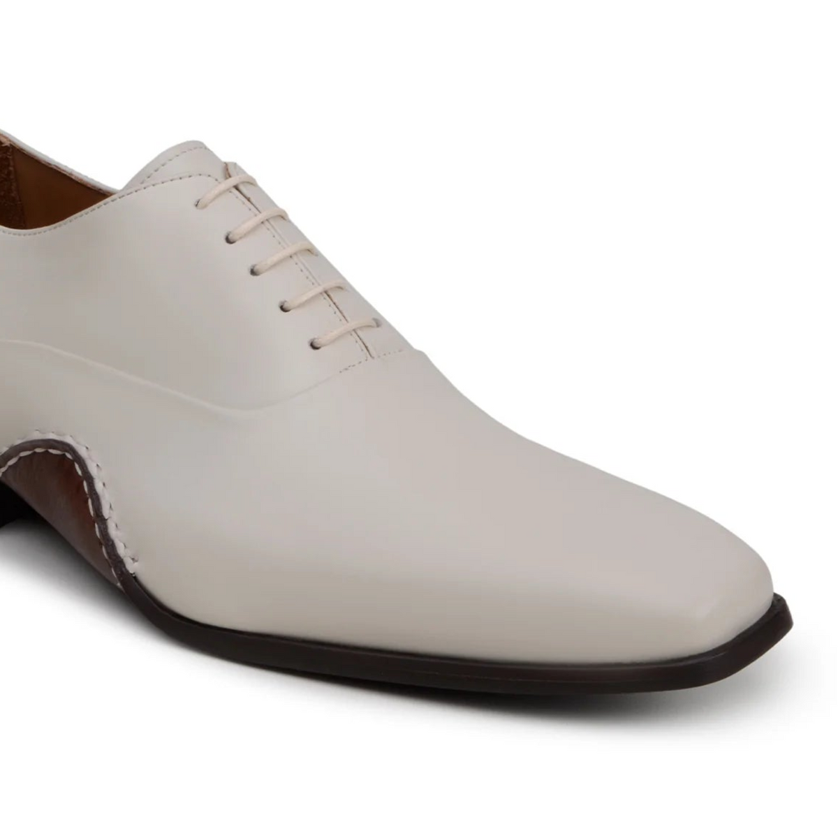 Angled view of light bone leather Oxford dress shoe