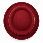 burgundy pork pie wool felt hat by Montique top view with wide brim and feather accent