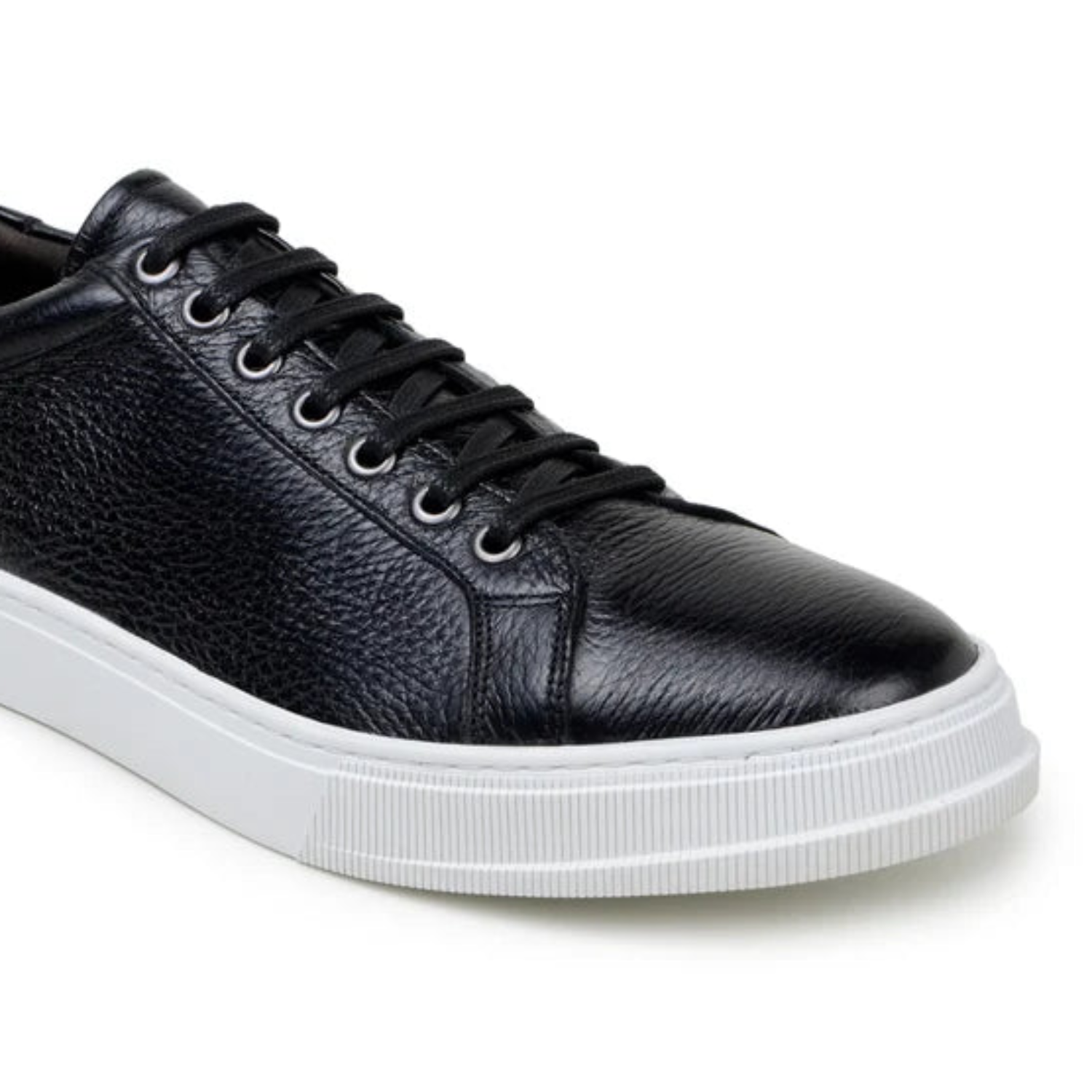 Side view of black deerskin sneaker with white sole