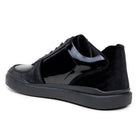 Rear three-quarter view of black Edmound sneaker showing panel construction