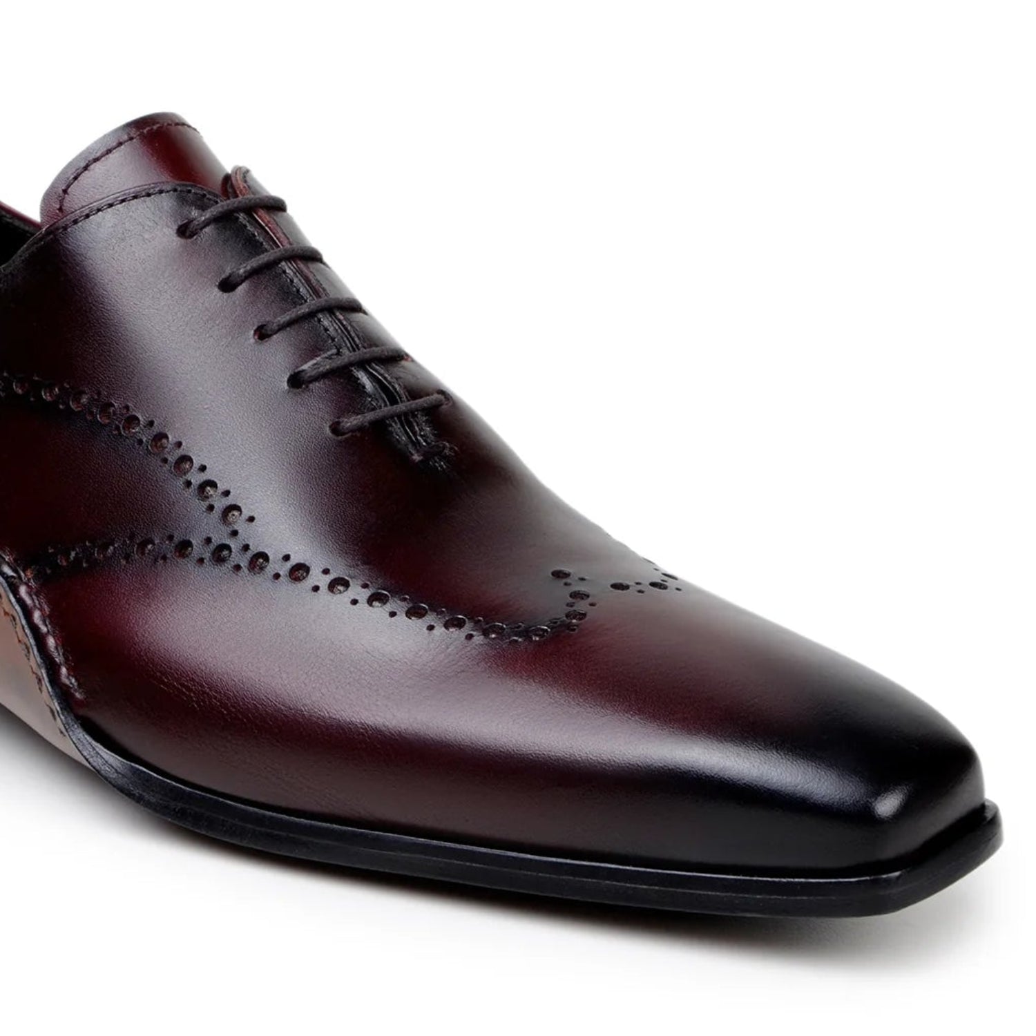 burgundy dress shoe perforated detailing close up