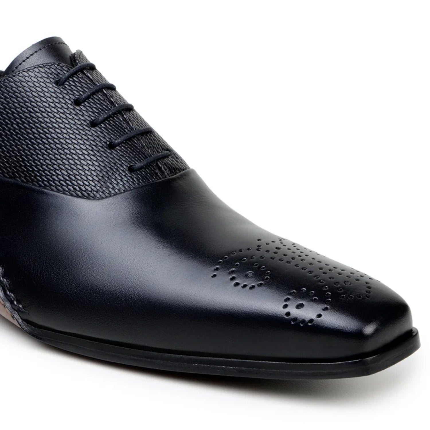 black oxford shoe perforated toe detail close up