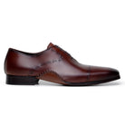 Side profile of antique cognac Maestro Oxford showing curved Opanka sole