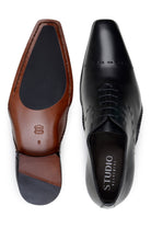 Top and leather outsole with rubber insert on black Maestro Oxford