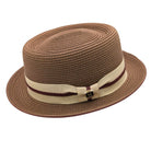Cappuccino Montique pork pie straw hat angled front view with beige band, burgundy cord trim, and logo pin