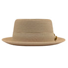 Beige Montique pork pie hat front view with flat crown, matching grosgrain ribbon bow, and logo pin