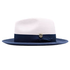 Navy and white Montique fedora hat side view with navy ribbon band, side bow, logo pin, white crown, and navy brim