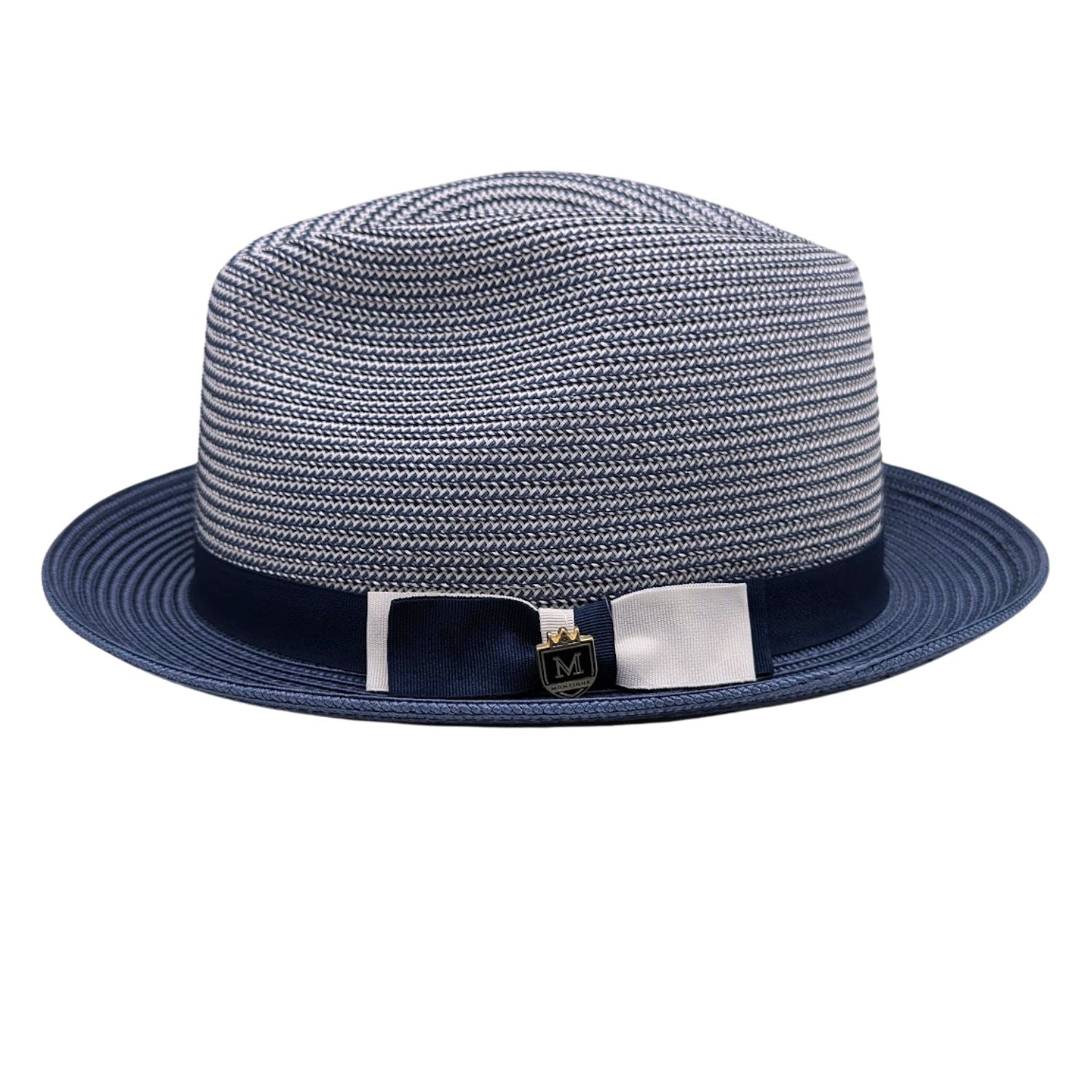 Navy Montique fedora hat side view with navy ribbon band, white bow accent, woven crown, and Montique logo pin