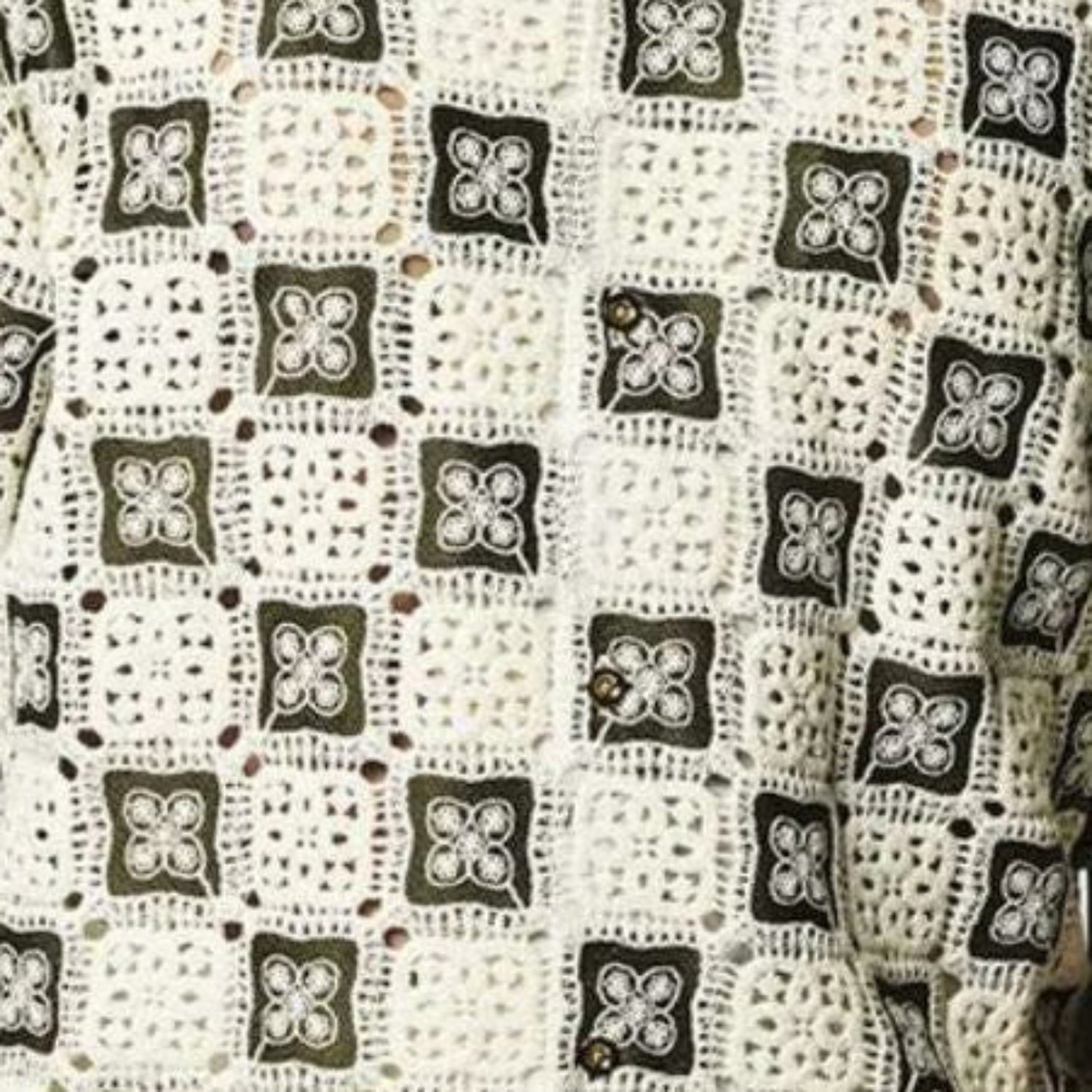 Close up of Stacy Adams oive and ivory crochet woven geometric fabric pattern