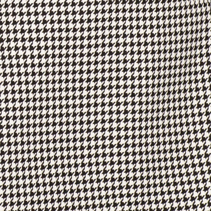 Close-up detail of black houndstooth suit jacket fabric pattern