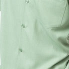 Close-up of apple 100% polyester fabric showing the solid texture and button detail