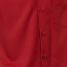 Close-up of cranberry 100% polyester fabric showing the solid texture and button detail