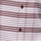 Close-up of burgundy geometric checkered shirt fabric from Montique walking suit