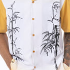 Close up of the Men's gold tropical leaf print walking suit with matching cuffed shorts
