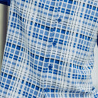 Close up of the men's cobalt plaid short sleeve walking suit with matching cuffed shorts
