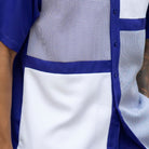 Close up of the Montique purple houndstooth color block walking suit with short sleeve shirt and shorts
