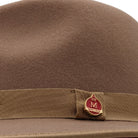 side view tan felt hat with red underside