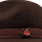 side view brown felt hat with red underside