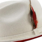 side view white hat with red underside and feather