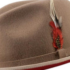 side view tan hat with red underside and feather
