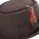 side view brown pork pie hat with feather and ribbon band