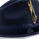 side view navy hat with white brim underside and feather