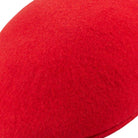 side view of red ascot cap in wool felt