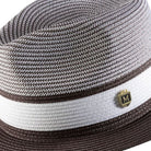 Close up of brown wide brim straw fedora hat pinch crown