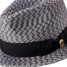 Side view woven fedora hat with black ribbon and pin