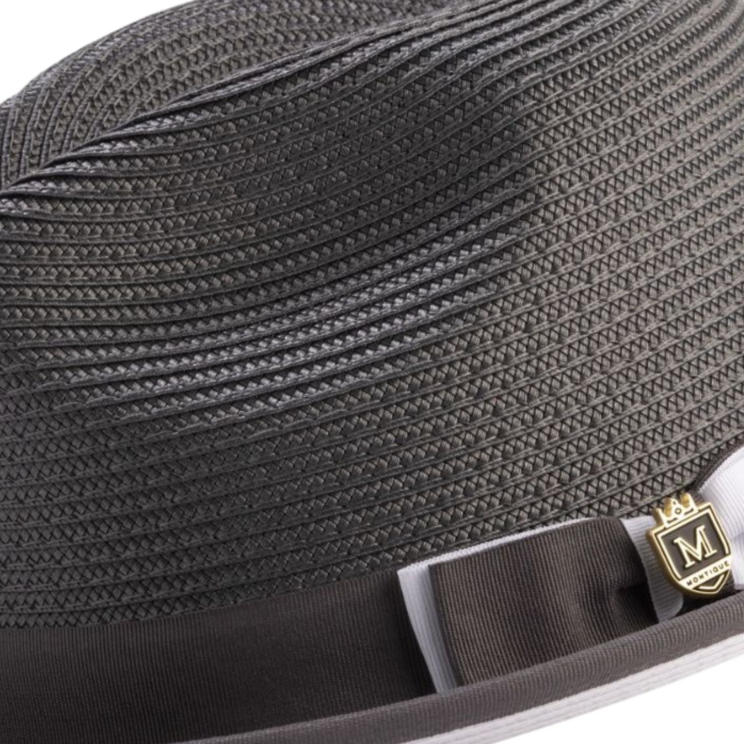 Grey straw hat with a grey white ribbon and gold emblem on a white background