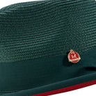 Men’s emerald pinch crown fedora hat with red underside brim and Montique pin