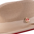Men’s tan pinch crown fedora hat with red underside brim and Montique pin