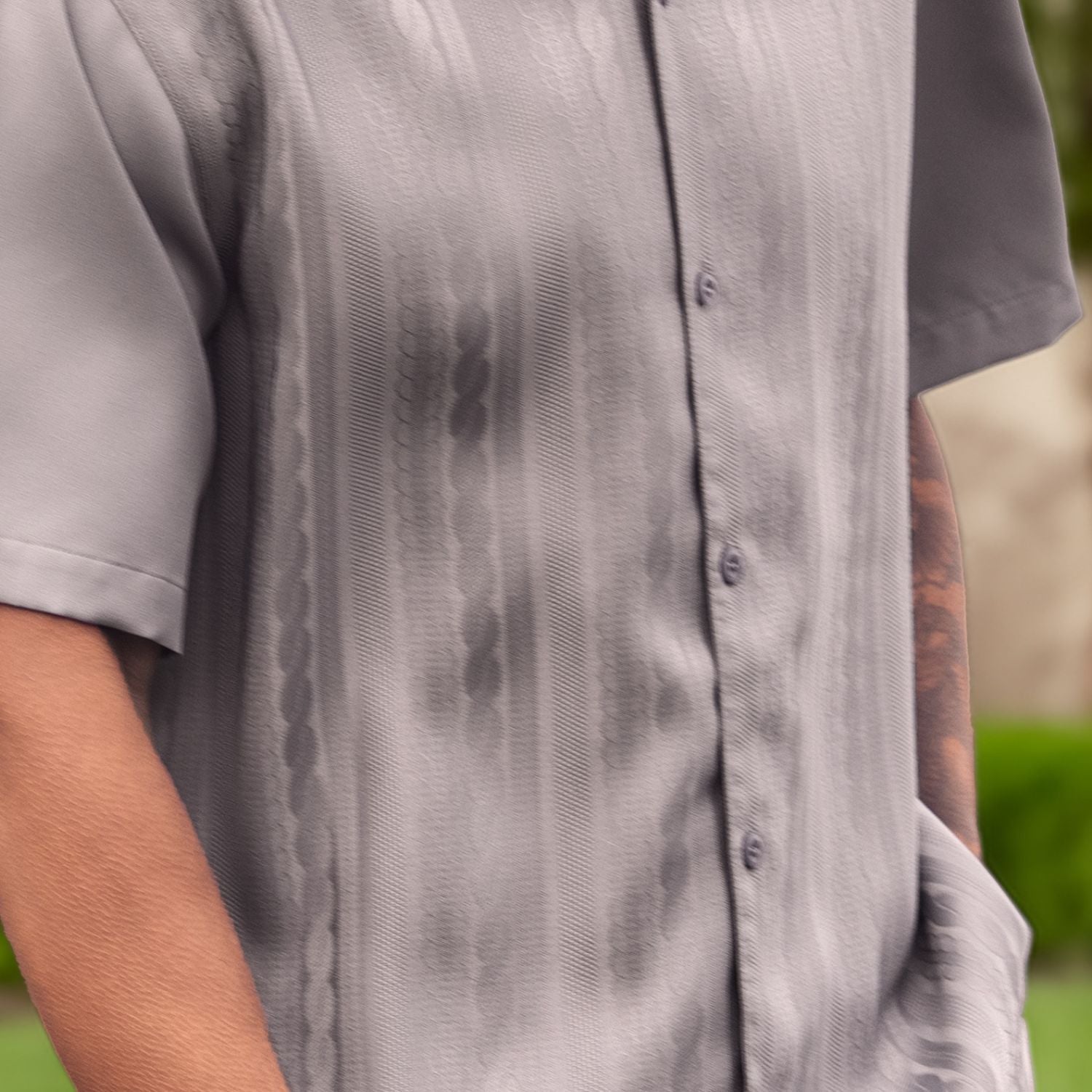 Close-up of grey walking suit shirt showing the detailed tone-on-tone cable knit texture.