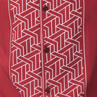 Red polyester men's walking suit shirt front close-up showing tonal geometric block panel puff detail.