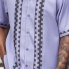 Close-up of lilac walking suit shirt showing the tonal contrast block panels and cuff trim detail.