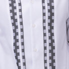 Close-up of white walking suit shirt showing the tonal contrast block panels and cuff trim detail.