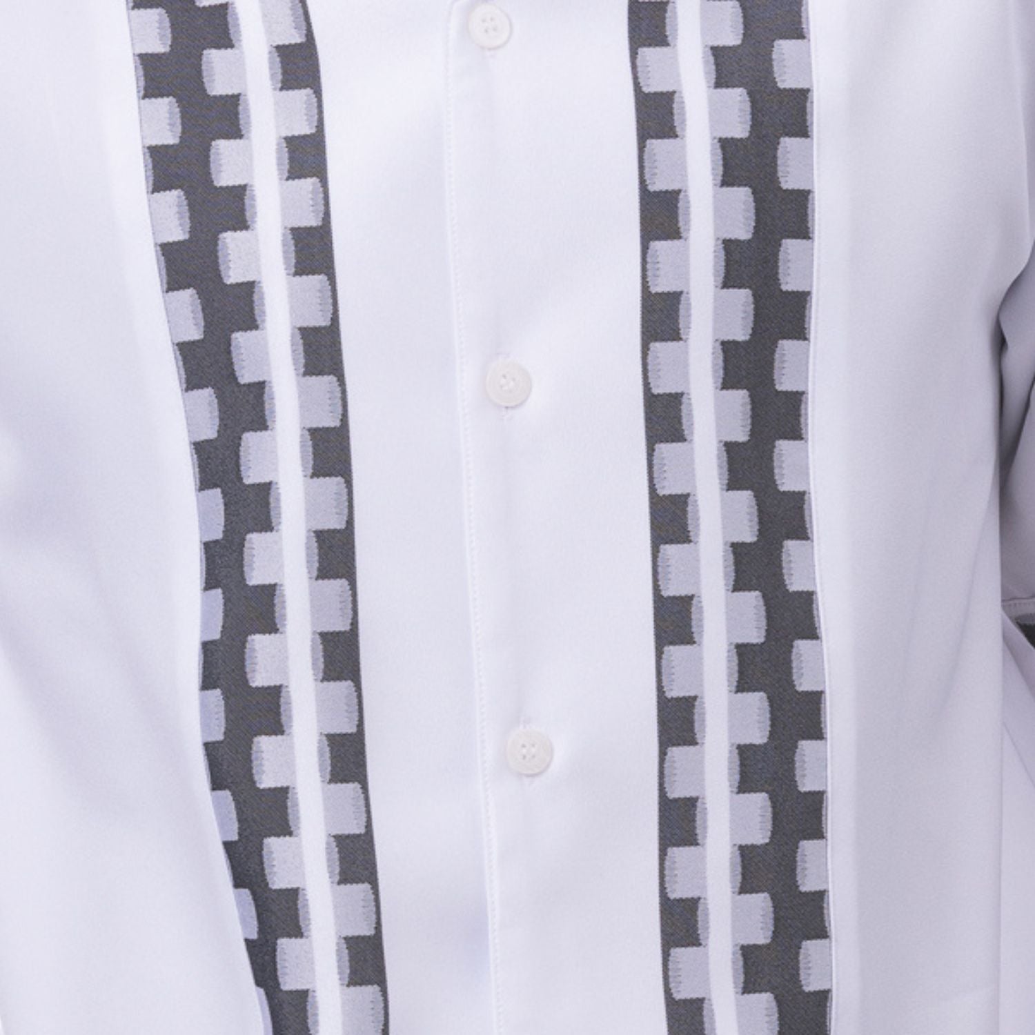 Close-up of white walking suit shirt showing the tonal contrast block panels and cuff trim detail.