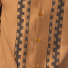 Close-up of cappuccino walking suit shirt showing the tonal contrast block panels and cuff trim detail.