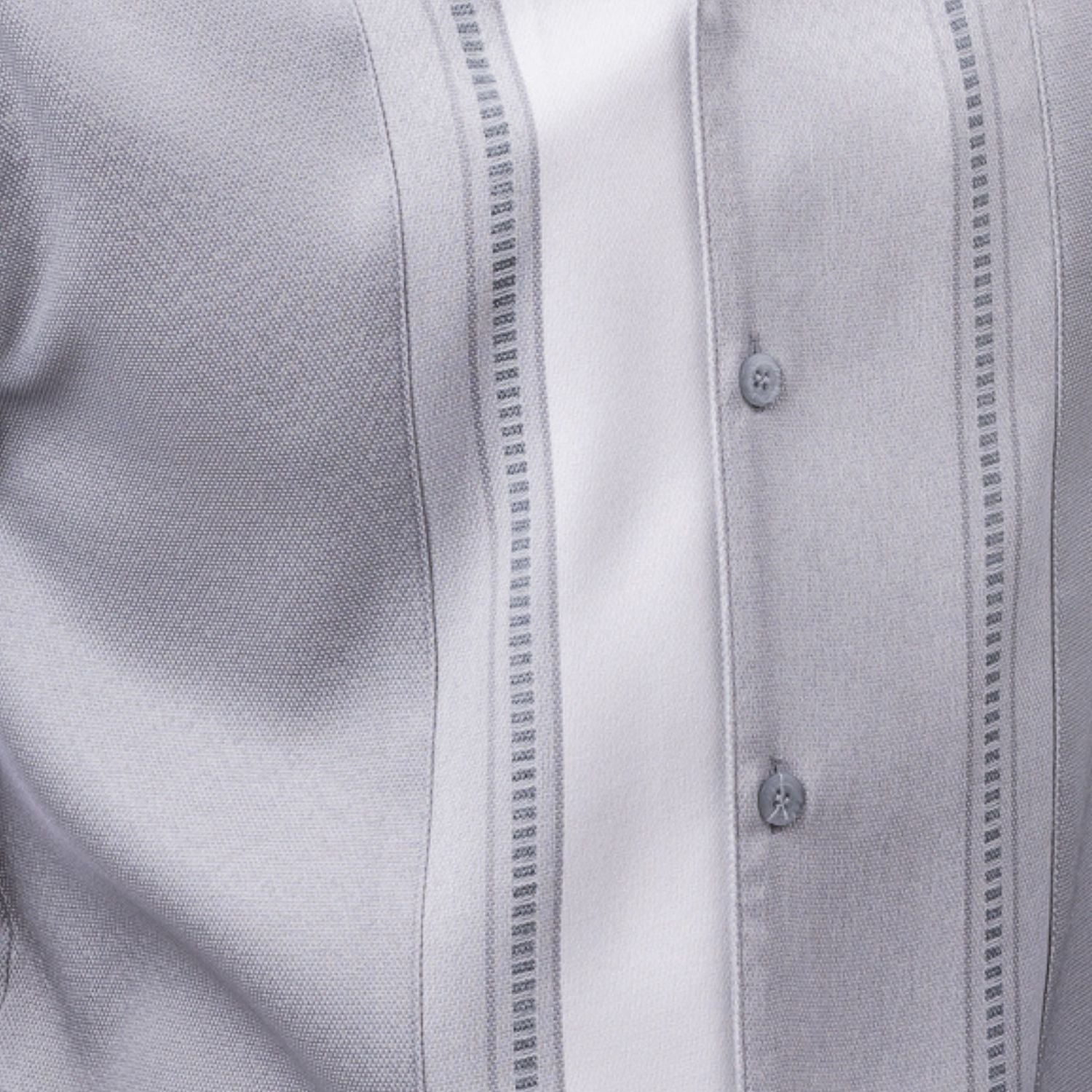 Close-up of grey walking suit shirt showing the white woven color-block panel and detailed stitched tracks.