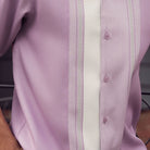 Close-up of lavender walking suit shirt showing the white woven color-block panel and detailed stitched tracks.