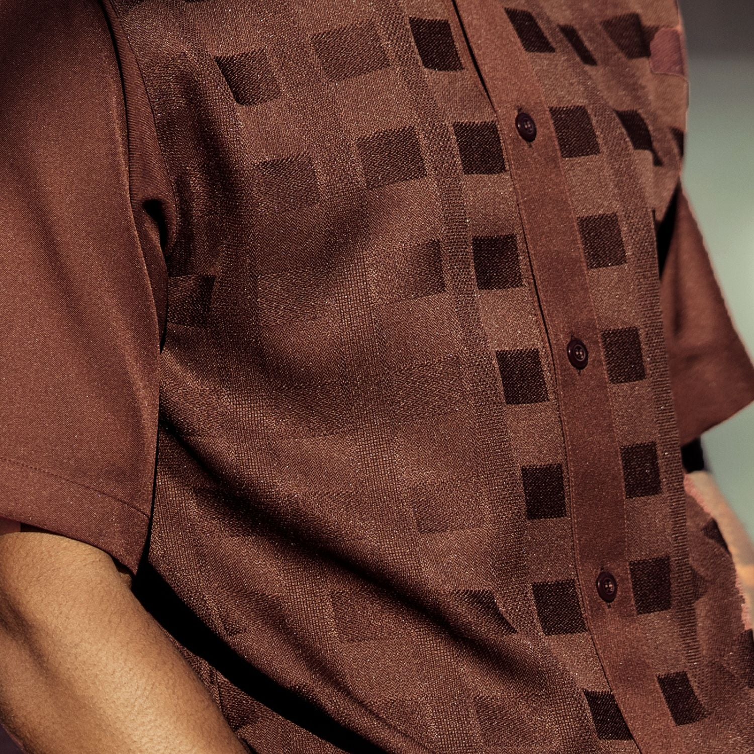 Close-up of brown walking suit shirt showing the detailed textured tone-on-tone weave pattern.