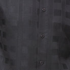 Close-up of black walking suit shirt showing the detailed textured tone-on-tone weave pattern.