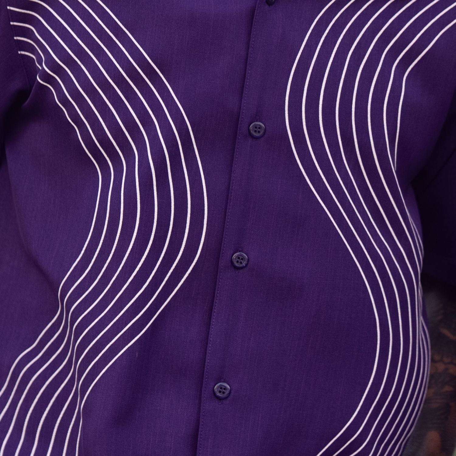 Close-up of purple walking suit shirt showing the detailed tonal multi-row puff stitched curved lines.