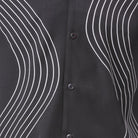 Close-up of black walking suit shirt showing the detailed tonal multi-row puff stitched curved lines.