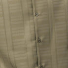 Close-up of olive men's walking suit shirt showing the subtle tone-on-tone textured weave pattern.