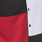 Close-up of black and red walking suit shirt showing the clean color block panels and coordinated tonal buttons.