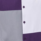 Close-up of purple and grey walking suit shirt showing the clean color block panels and coordinated tonal buttons.