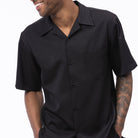 Front view of the black solid short sleeve men's walking suit shirt.