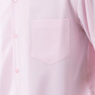Close-up of pink 100% polyester fabric showing the solid texture and button detail